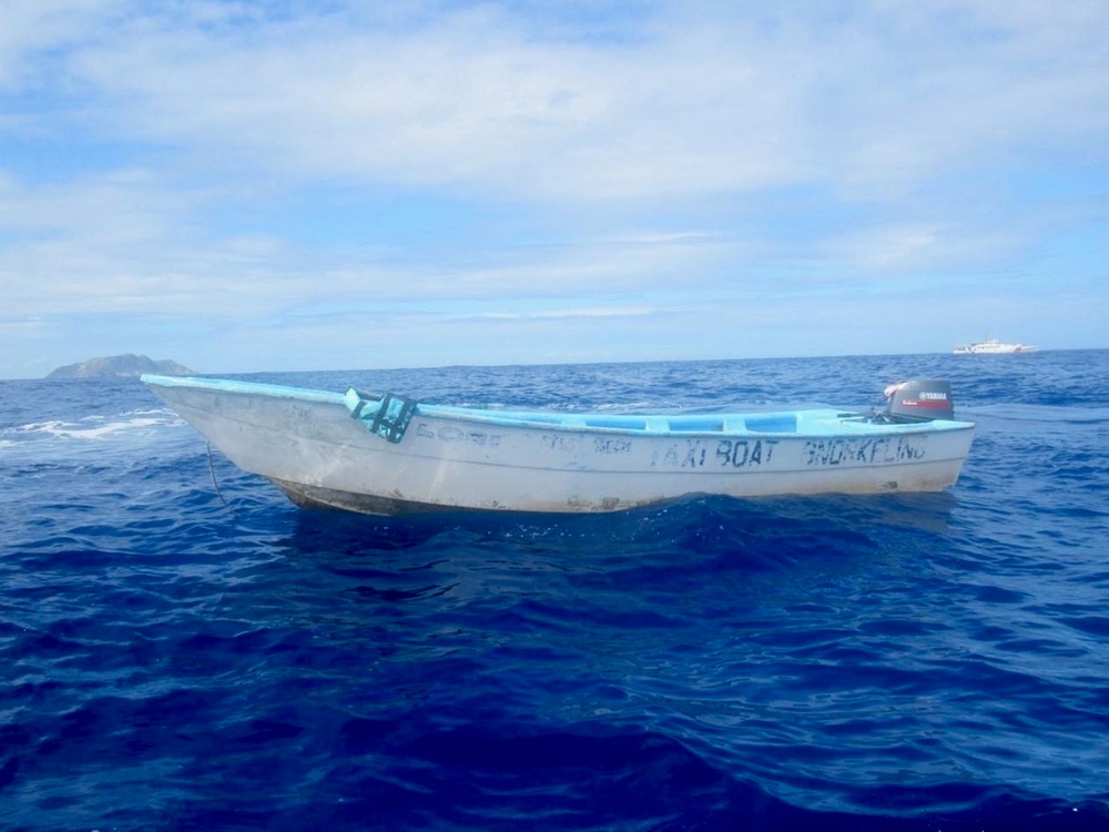 The Coast Guard Cutter Heriberto Hernandez is on-scene with a makeshift boat that was part of an illegal voyage interdicted by a Puerto Rico Police marine unit near Rincon, Puerto Rico Feb. 11, 2022. The interdicted group was comprised of 9 Haitians and four Dominican Republic nationals, who were returned to the Dominican Republic. (U.S. Coast Guard photo).