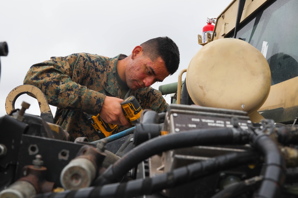 Marines with 5th Marine Regiment prepare vehicles for inspection