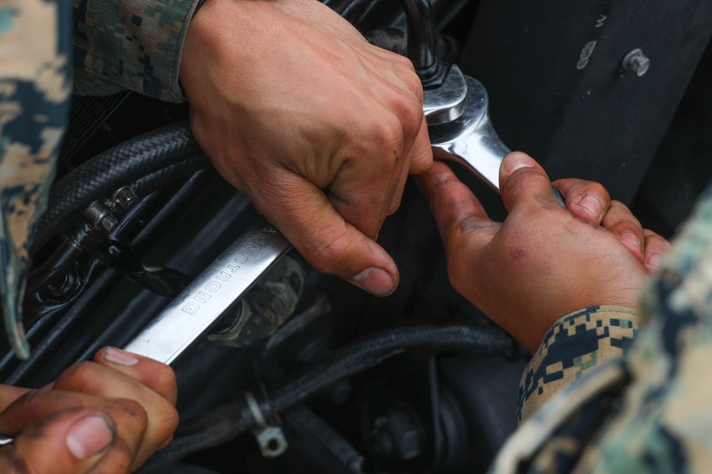 Marines with 5th Marine Regiment prepare vehicles for inspection