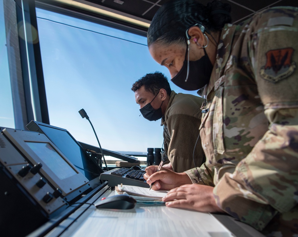 Air Traffic Control Airmen monitor, communicate with aircraft