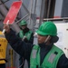 Sailor signals during underway replenishment