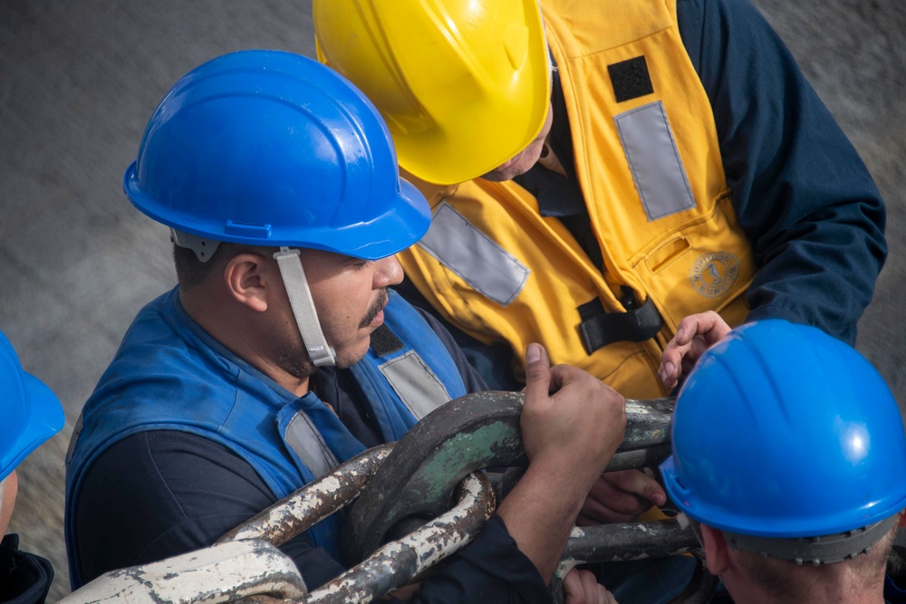 Sailors connect hook during underway replenishment