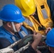 Sailors connect hook during underway replenishment