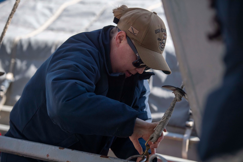 Sailor secures hoisting line to ship