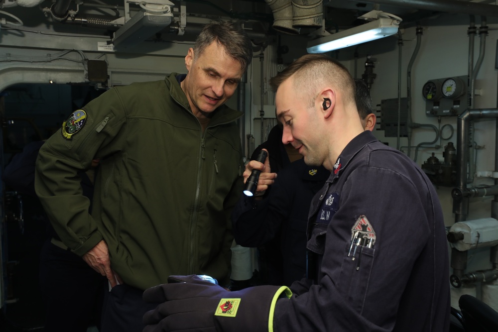 Rear Adm. Curt Renshaw, commander, Carrier Strike Grop Eight, tours engineering department spaces.