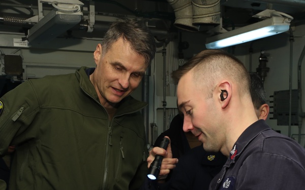 Rear Adm. Curt Renshaw, commander, Carrier Strike Grop Eight, tours engineering department spaces.