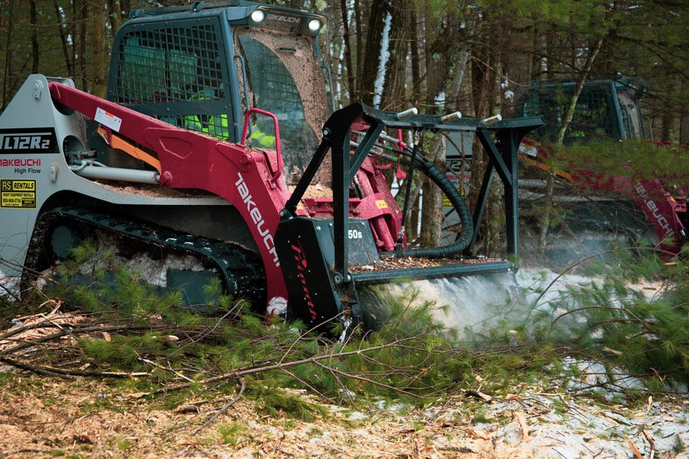 Forestry heavy equipment operator mulching a tree