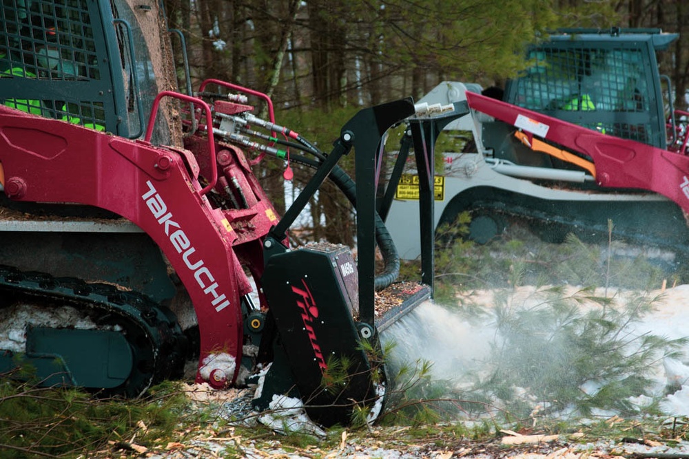 Forestry heavy equipment operators clearing underbrush