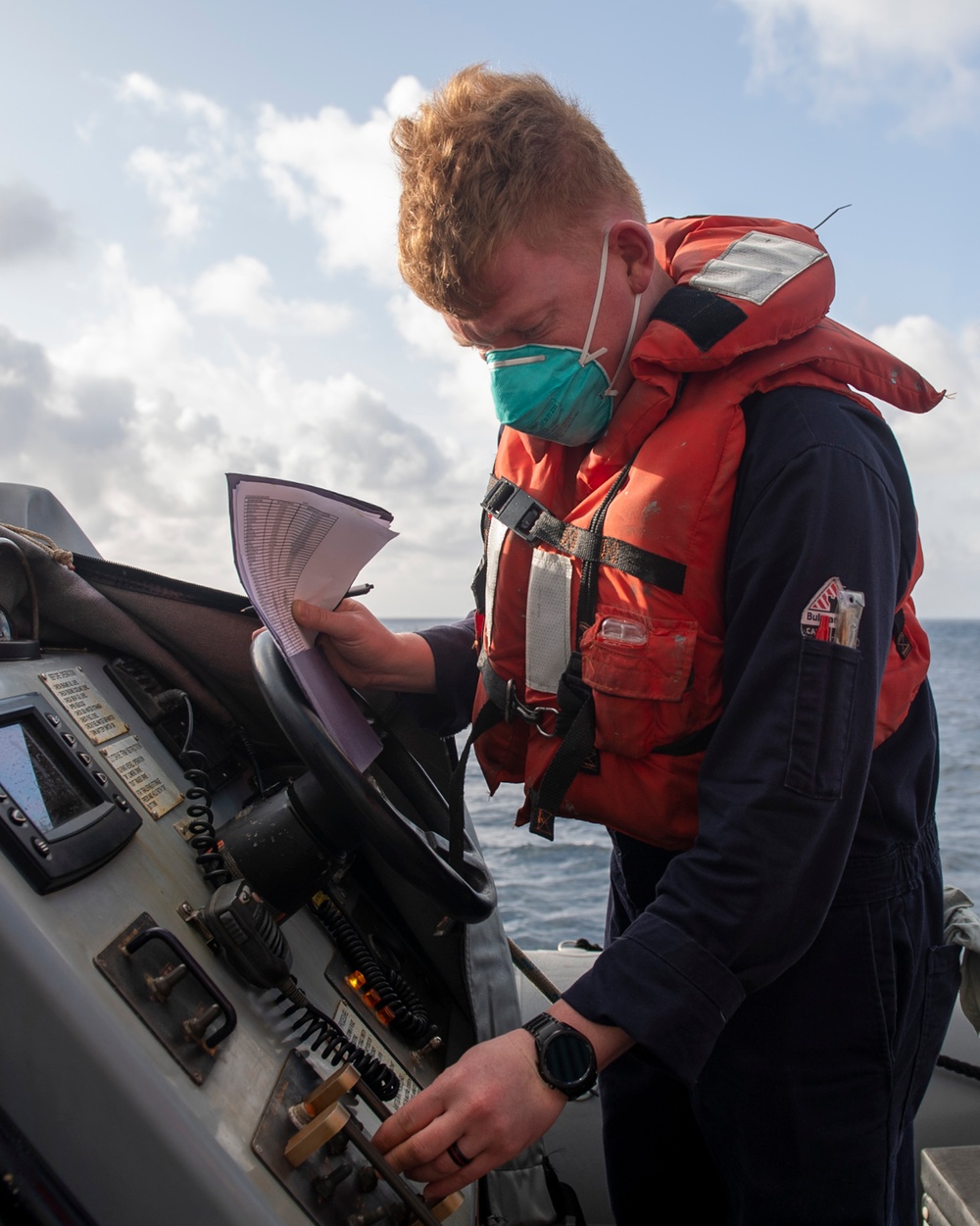 Machinist Mate 3rd Class Andrew Harney, from Bend, Ore., conducts a boat report