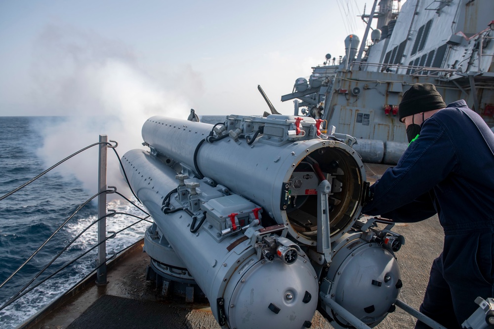 Gunner’s Mate 2nd Class Jay Davis, from Virginia Beach, Va., fires and air slug