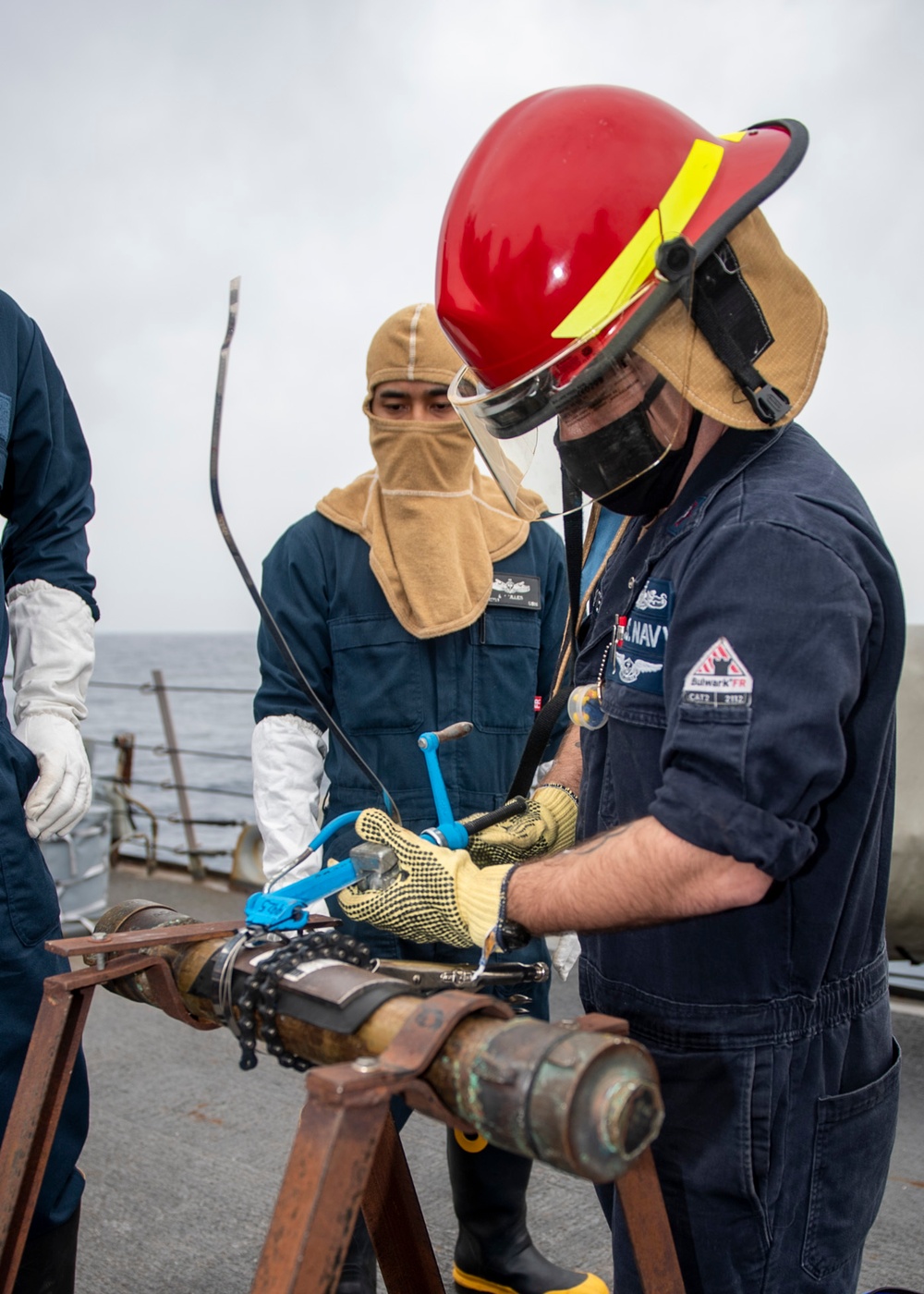 Damage Controlman 1st Class Adam Foster, from Norfolk, Va., patches a pipe