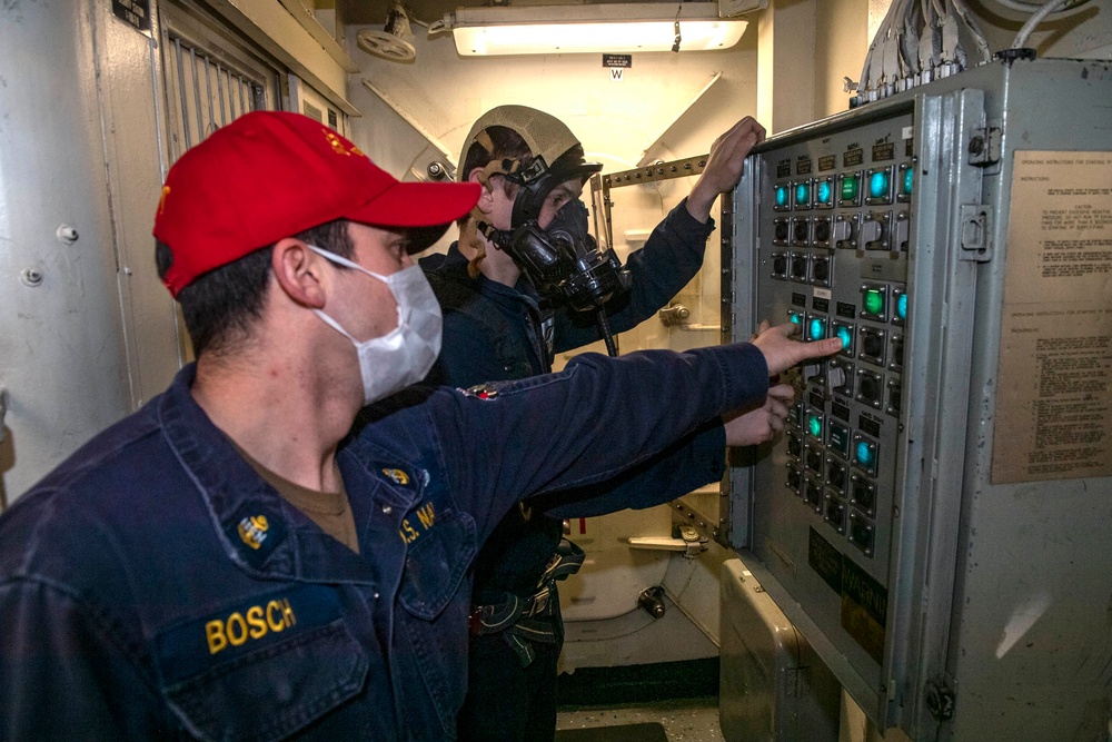 Chief Electrician’s Mate Jay Bosch, from Rochester, N.Y., instructs Electrician’s Mate Fireman Kevin Gee, from Columbus, Ohio, on control panel shutdown procedures