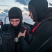Logistics Specialist 2nd Class Bryce Braltierra (right), from Apache, Okla., helps Gas Turbine Systems Technician 3rd Class David Chiarizzi (left), from Long Island, N.Y., don Search and Rescue gear