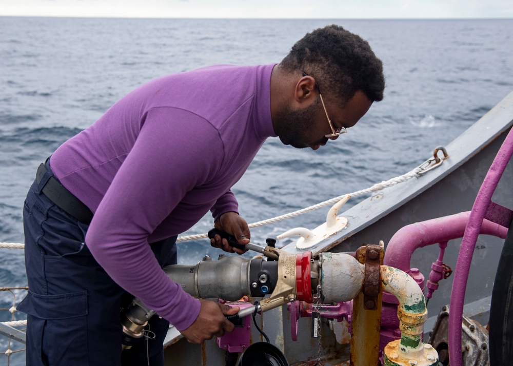 Gas Turbine Systems Technician 3rd Class Demario Spencer, from Monroe, La., connects a fuel line