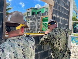 NMCB THREE Seabees measure windowsill at existing police station project