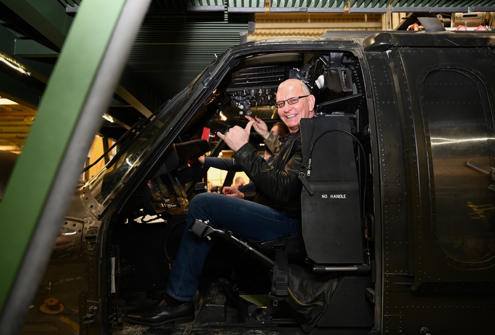 Chef Robert Irvine Receiving a Demonstration of an Blackhawk Simulator