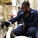 USS Ross Sailors polish brass equipment