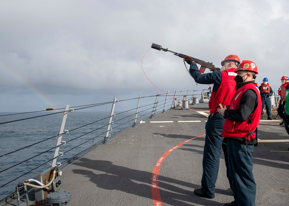 Sailors shoot a shot line to the Royal Canadian navy auxiliary replenishment oiler MV Asterix during a replenishment-at-sea aboard Arleigh Burke-class guided-missile destroyer USS Mitscher (DDG 57)
