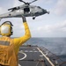 Sailor signals to aircraft aboard USS Gonzalez.