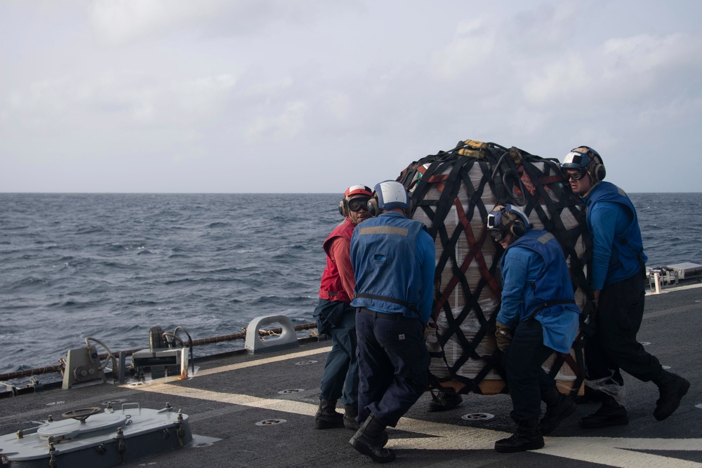 Sailors move cargo aboard USS Gonzalez.