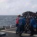 Sailors move cargo aboard USS Gonzalez.