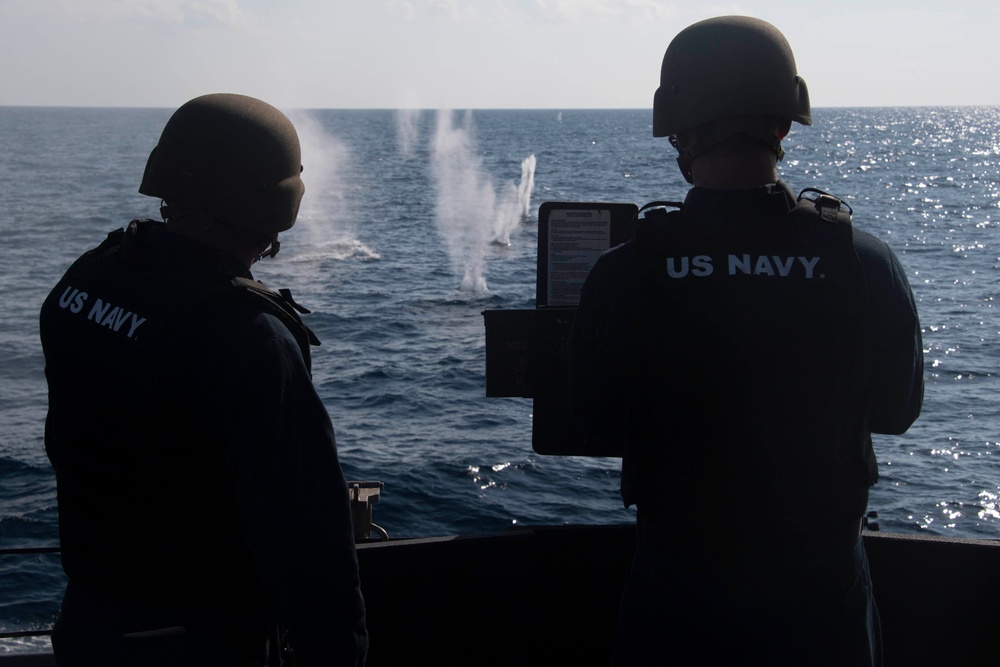 Sailor fires .50-caliber machine gun during a live-fire event aboard USS Gonzalez