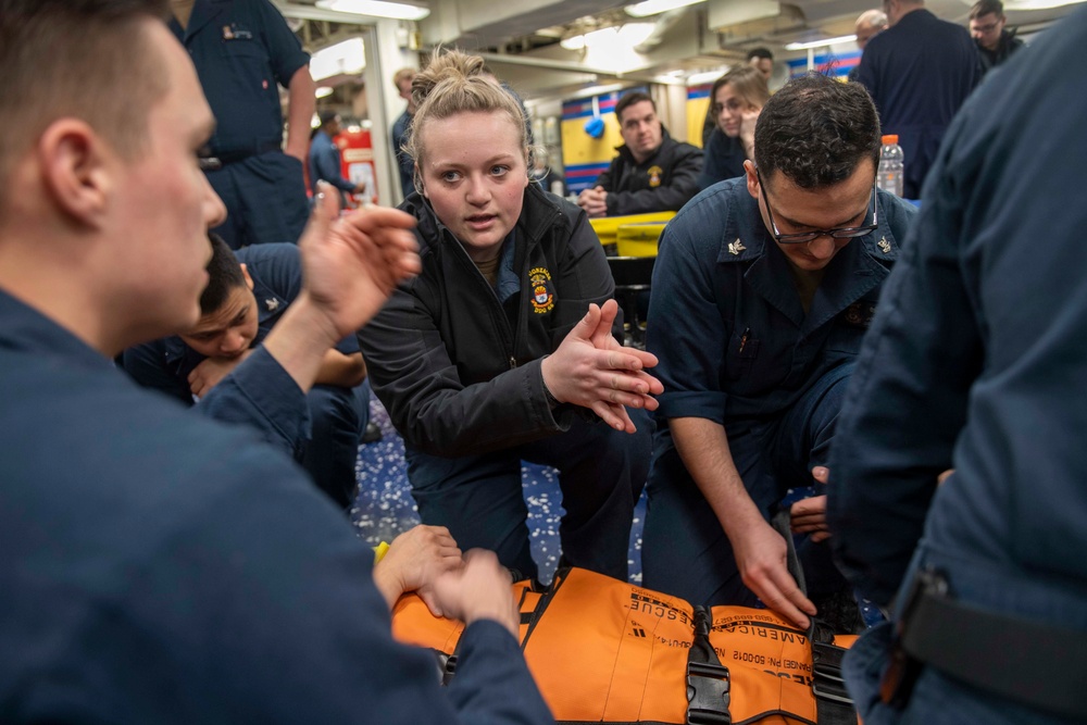 Sailor gives training during stretcher bearer training aboard USS Gonzalez.