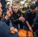 Sailor gives training during stretcher bearer training aboard USS Gonzalez.