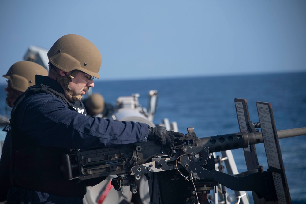 Sailor fires .50-caliber machine gun during a live-fire event aboard USS Gonzalez