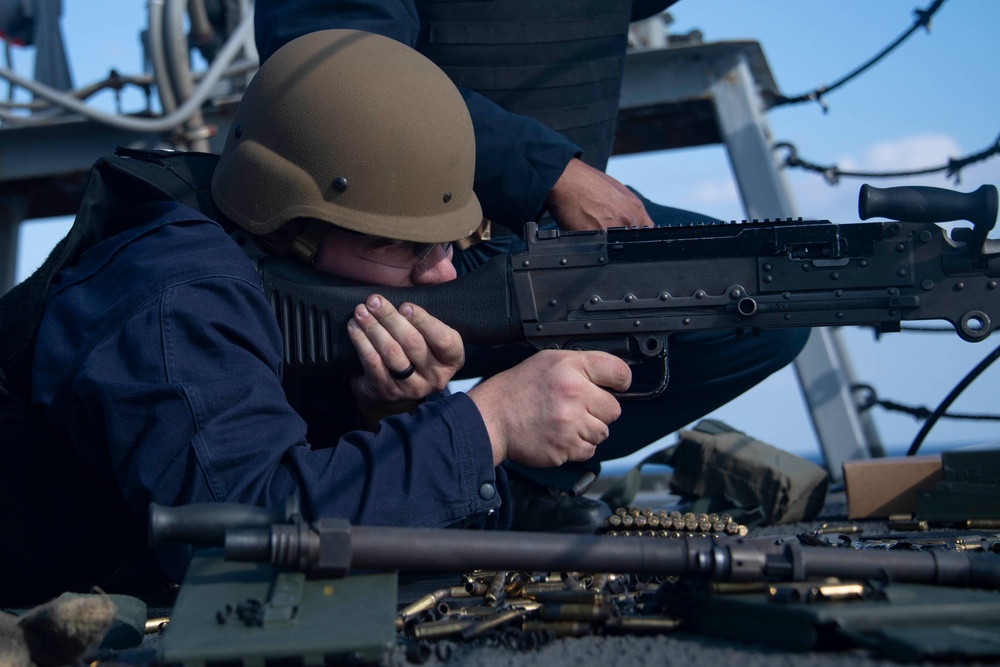 Sailor fires M240B machine gun during a live-fire event aboard USS Gonzalez.