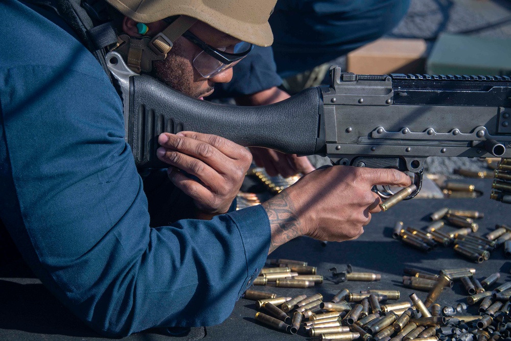 Sailor fires M240B machine gun during a live-fire event aboard USS Gonzalez.