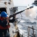 Sailor fires shot line during a replenishment-at-sea.