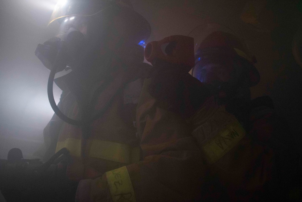 Sailors fight simulated fire.