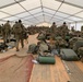 82nd Airborne Division place their equipment inside a tent as they settle in to their new location