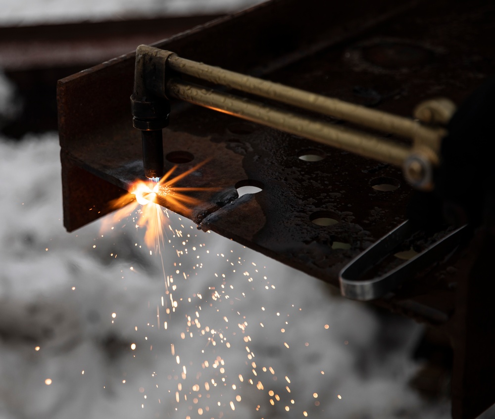 Firefighter Utilizes Metal-Cutting Torch During Exercise Arctic Eagle-Patriot 2022