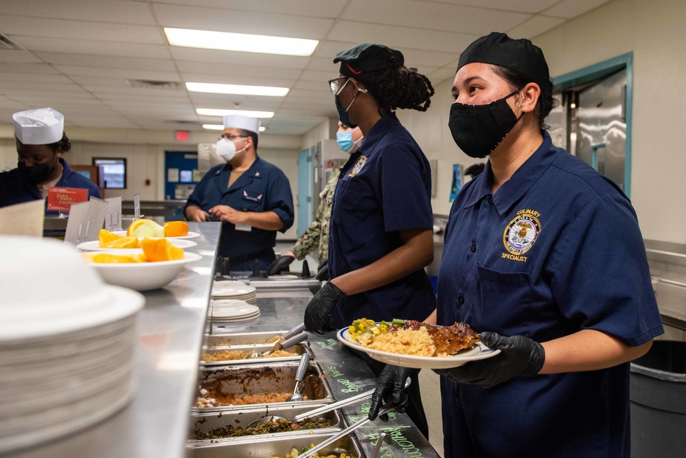 U.S. Navy Culinary Specialist Julynta Kabua, from Uliga, Marshall Islands, serves food at the Black History Month commemorative lunch