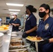 U.S. Navy Culinary Specialist Julynta Kabua, from Uliga, Marshall Islands, serves food at the Black History Month commemorative lunch