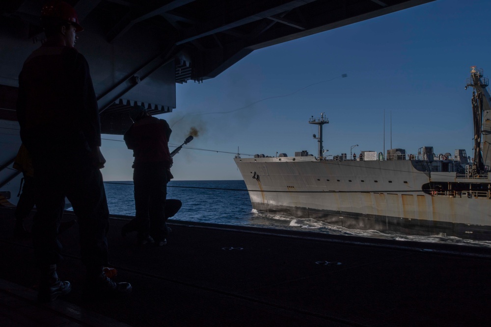 Sailor Shoots Shot Line During A Replenishment At Sea