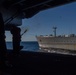 Sailor Shoots Shot Line During A Replenishment At Sea