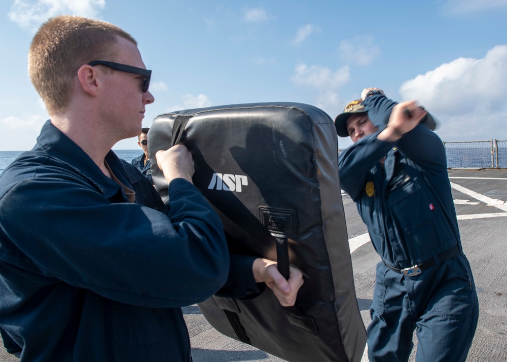 Cryptologic Technician (Collection) Seaman Apprentice Hadyn Randall, left, from Commercial Point, Ohio, blocks a baton strike from Master-at-Arms 1st Class Trenton McKibben, right, from Orlando, Fla., during a Security Reaction Force – Basic training