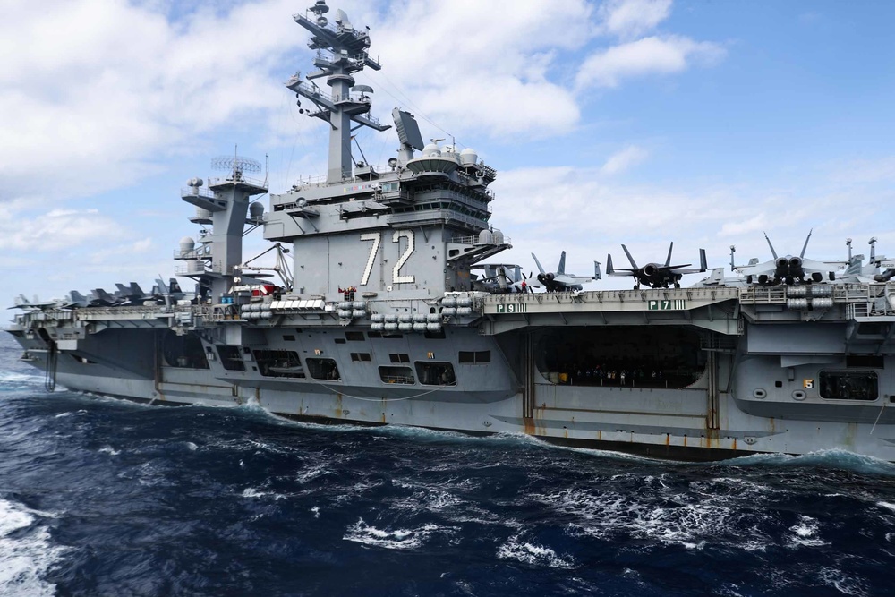 Abraham Lincoln conducts a replenishment-at-sea with Mobile Bay