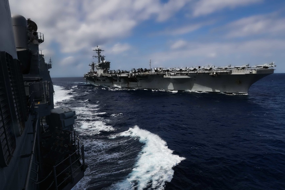Abraham Lincoln conducts a replenishment-at-sea with Mobile Bay