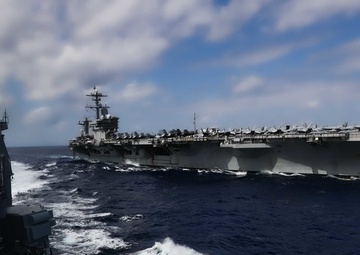 Abraham Lincoln conducts a replenishment-at-sea with Mobile Bay