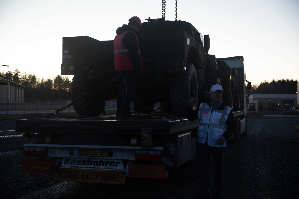 Soldiers and civilians assigned to 624th Movement Control Team download equipment at Grafenwoehr Training Area