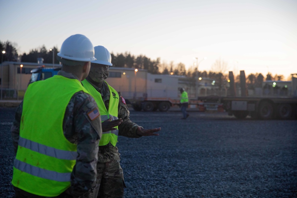 Soldiers and civilians assigned to 624th Movement Control Team download equipment at Grafenwoehr Training Area