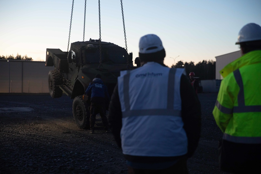 Soldiers and civilians assigned to 624th Movement Control Team download equipment at Grafenwoehr Training Area