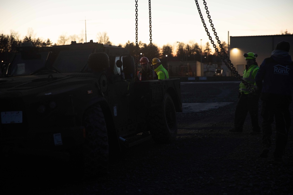 Soldiers and civilians assigned to 624th Movement Control Team download equipment at Grafenwoehr Training Area