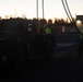 Soldiers and civilians assigned to 624th Movement Control Team download equipment at Grafenwoehr Training Area