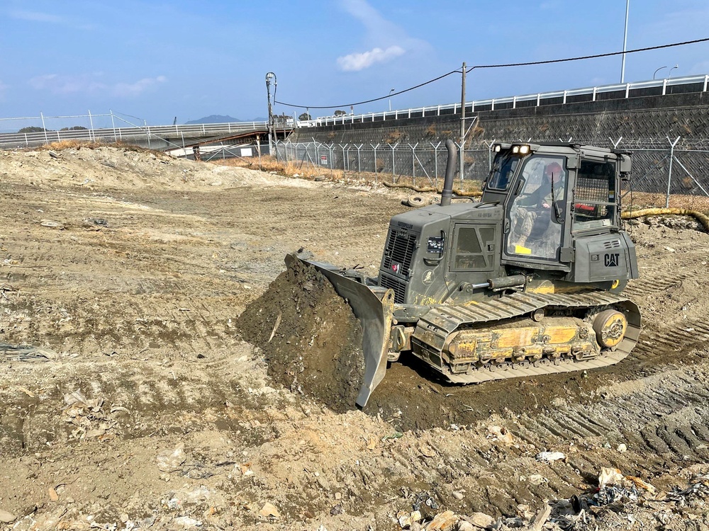 9th Engineer Support Battalion Marine operates a D6K Dozer cutting material to achieve proper elevation