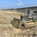9th Engineer Support Battalion Marine operates a D6K Dozer cutting material to achieve proper elevation